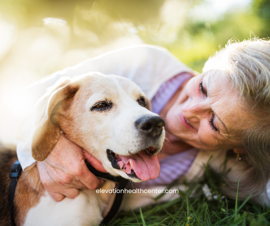 woman with peripheral neuropathy playing happily with dog