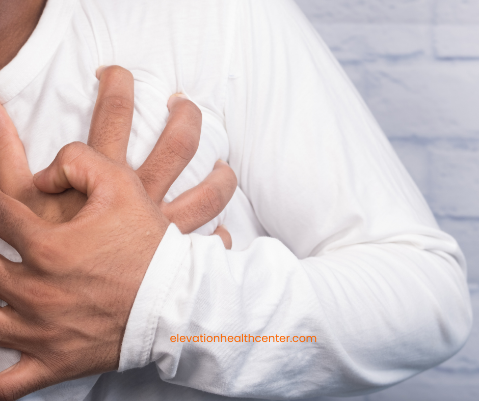 man holding chest due to high blood pressure