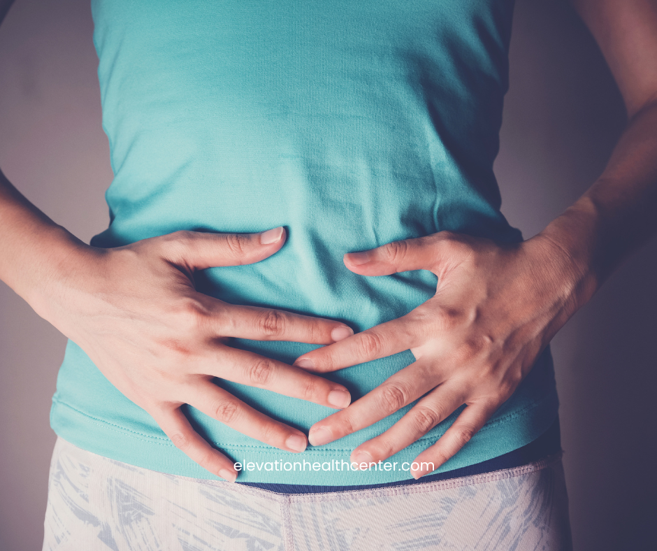 woman holding gut due to chronic inflammation