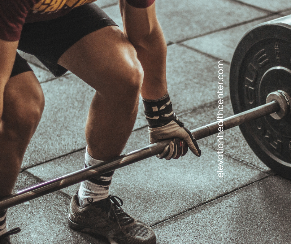 Man lifting weights that can use red light therapy for muscle recovery