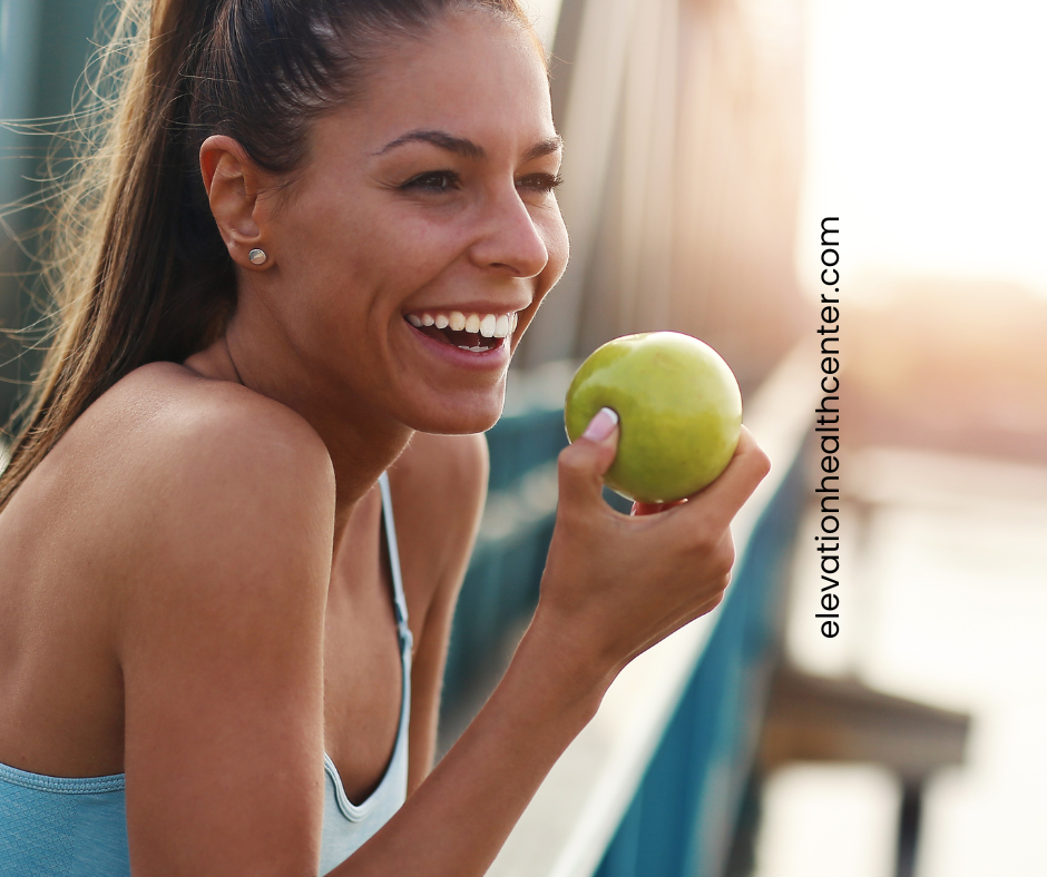 Woman eating apple for digestive health