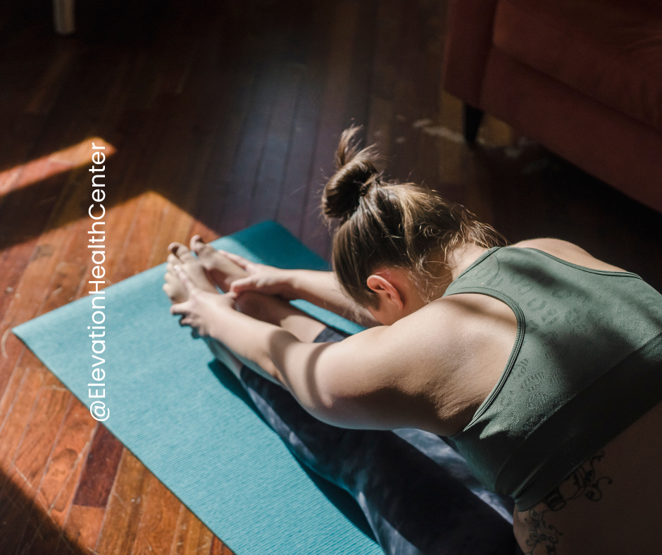 woman doing essential stretch to boost results of chiropractic adjustments